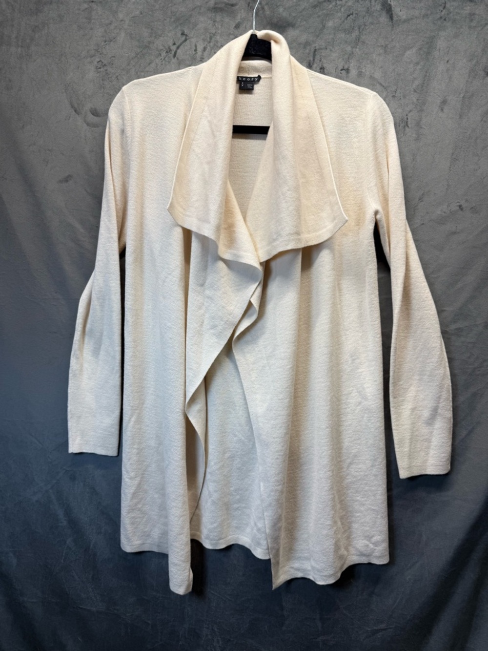 Distinctive VTG Theory waterfall cream cardigan features asymmetric draped hem.